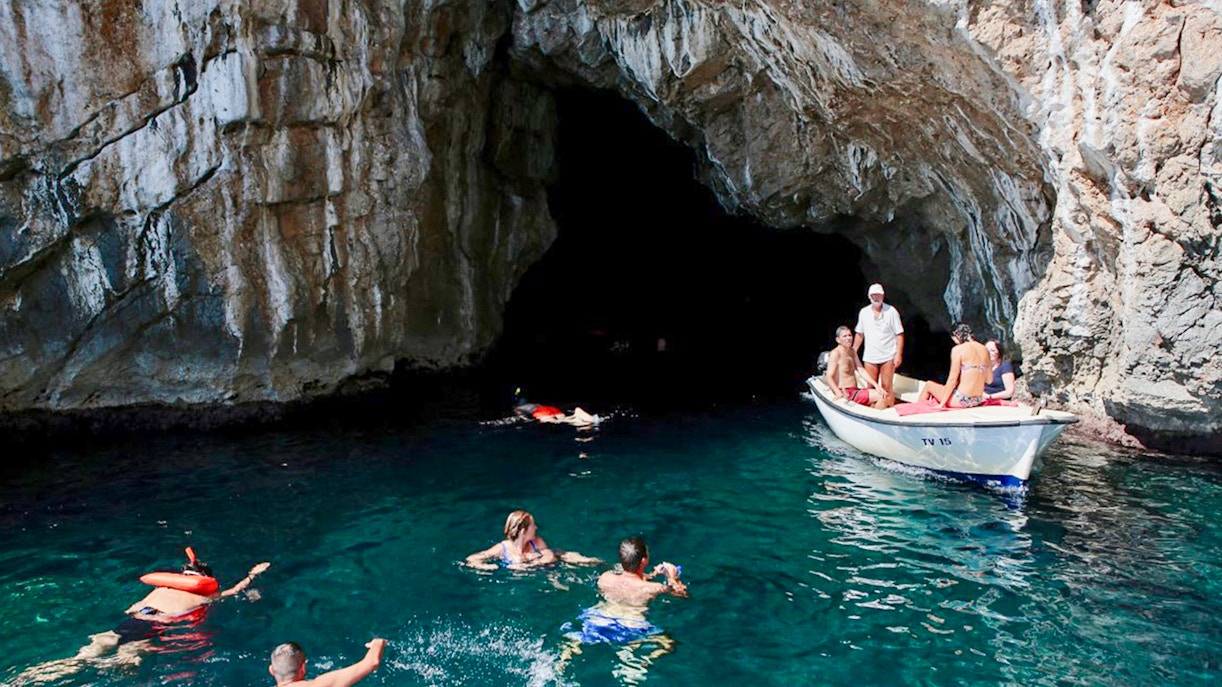 Swimmers exploring the Blue Cave, Kotor, Montenegro.