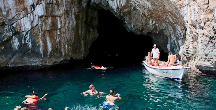 Swimmers exploring the Blue Cave, Kotor, Montenegro.