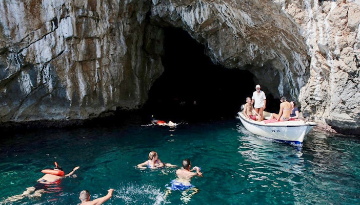 Swimmers exploring the Blue Cave, Kotor, Montenegro.