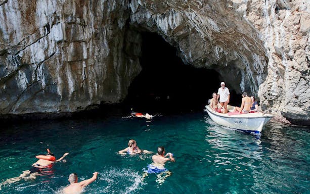 Swimmers exploring the Blue Cave, Kotor, Montenegro.