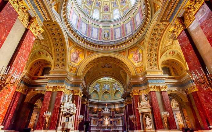 St. Stephen's Basilica interior with ornate dome and columns in Budapest, Hungary.