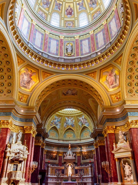 St. Stephen's Basilica interior with ornate dome and columns in Budapest, Hungary.