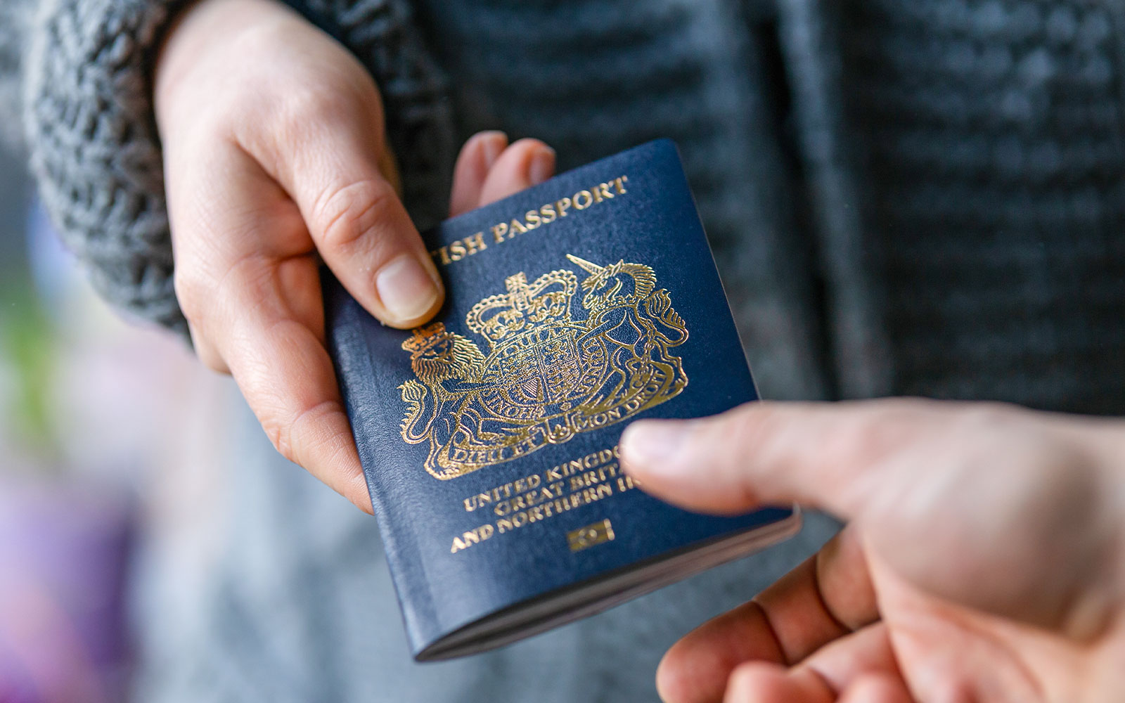 Handing passport to security at check-in counter.