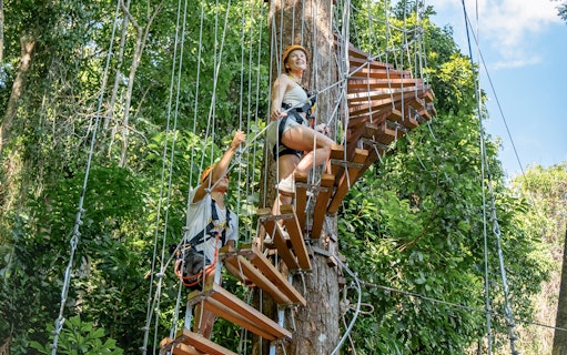 Participants climbing a spiral staircase for the Erawan Patong Seaview Zipline in Phuket.
