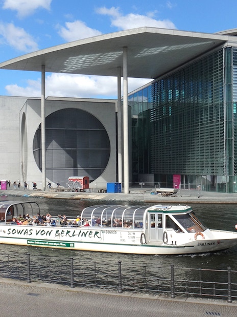 Sightseeing boat on the Spree River near the Marie-Elisabeth-Lüders-Haus in Berlin Mitte.