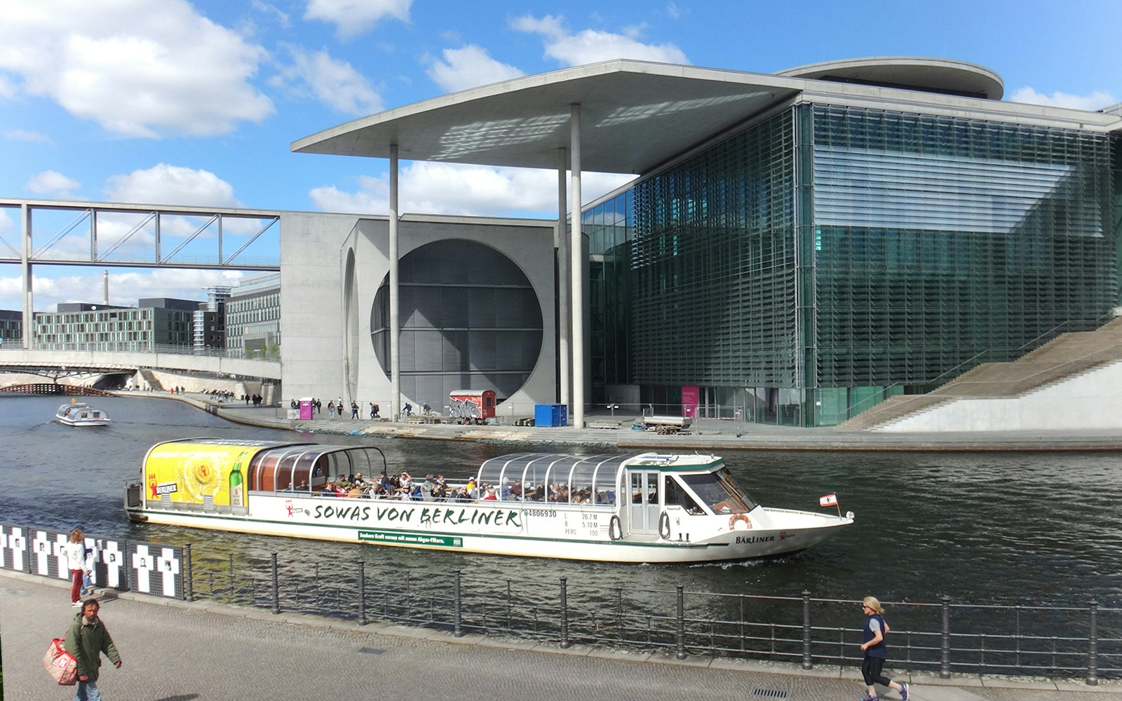 Sightseeing boat on the Spree River near the Marie-Elisabeth-Lüders-Haus in Berlin Mitte.