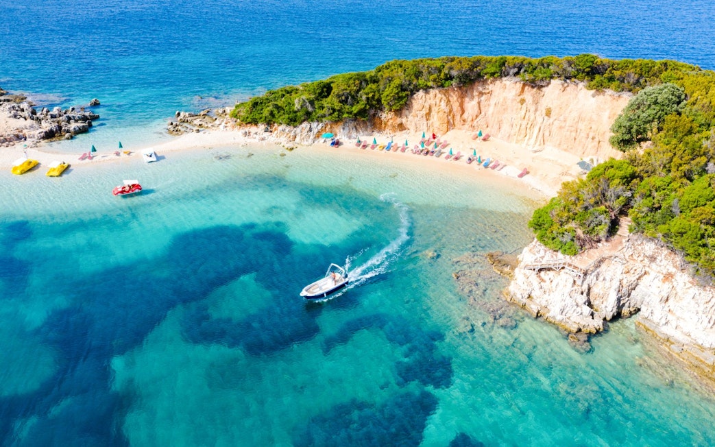 Aerial view of a boat near the Tetran Archipelago beach, Ksamil, Albania.