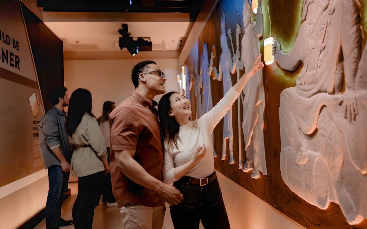 Tourists exploring interactive exhibit at Pilsner Urquell The Original Beer Experience.