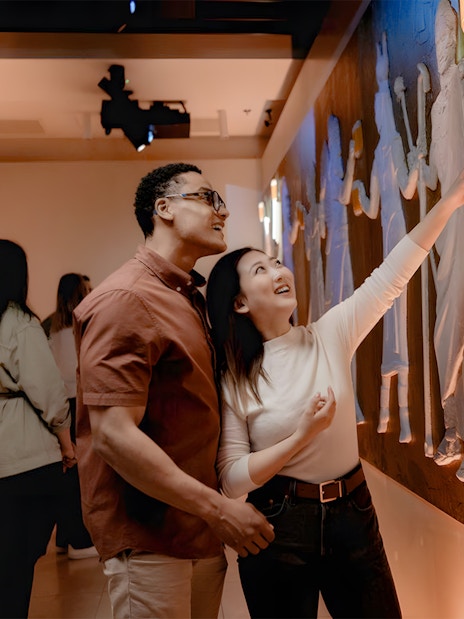 Tourists exploring interactive exhibit at Pilsner Urquell The Original Beer Experience.