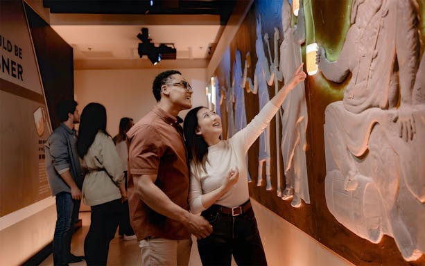 Tourists exploring interactive exhibit at Pilsner Urquell The Original Beer Experience.
