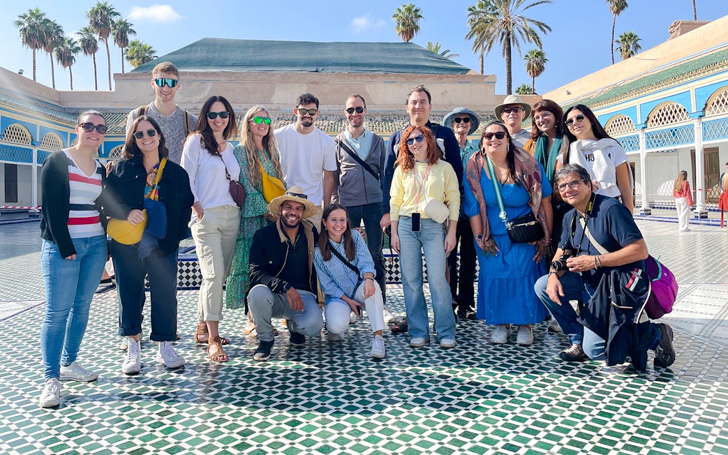 Group of tourists at Bahia Palace courtyard in Marrakech, Morocco.