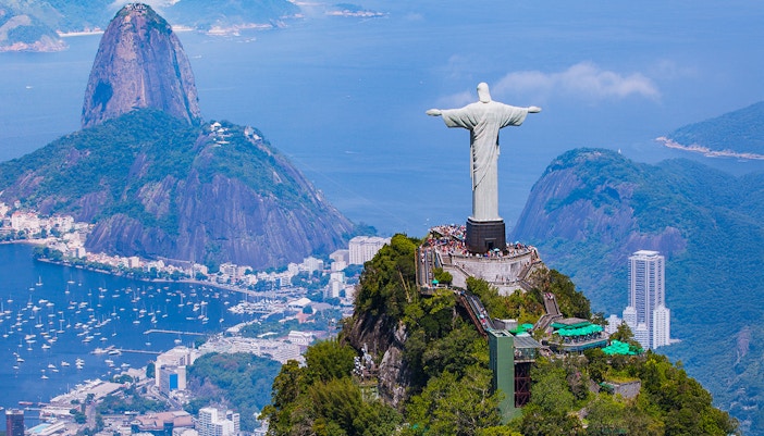 Christ the Redeemer overlooking Rio de Janeiro with Sugarloaf Mountain in the background.