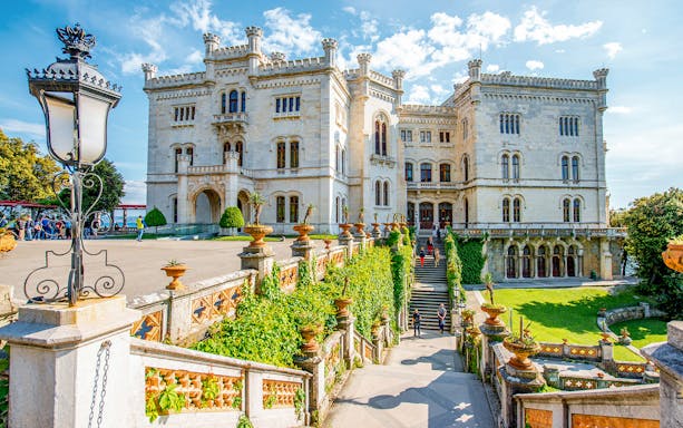 Miramare Castle entrance with visitors on a guided tour in Trieste, Italy.