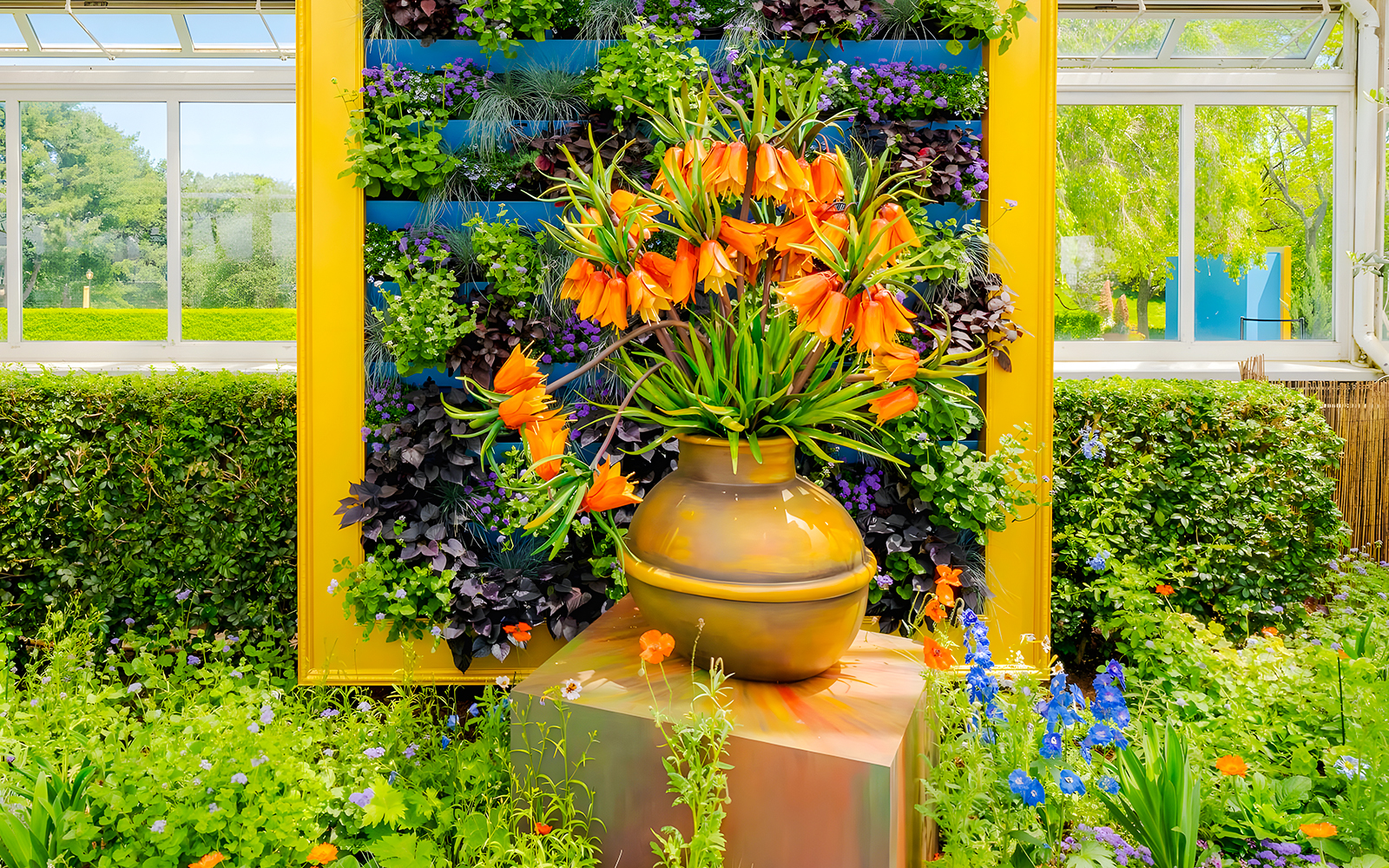 Van Gogh-inspired orange flowers in a vase at New York Botanical Garden exhibit.