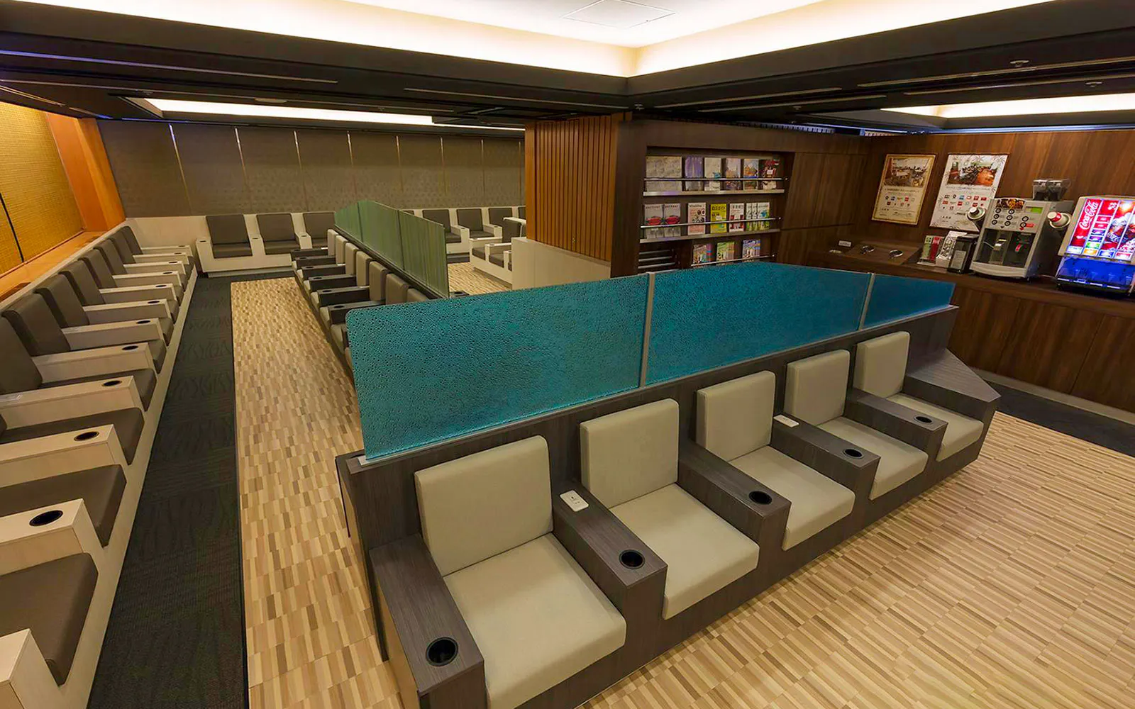 Waiting area seating at Narita International Airport Terminal 1 lounge with refreshments.