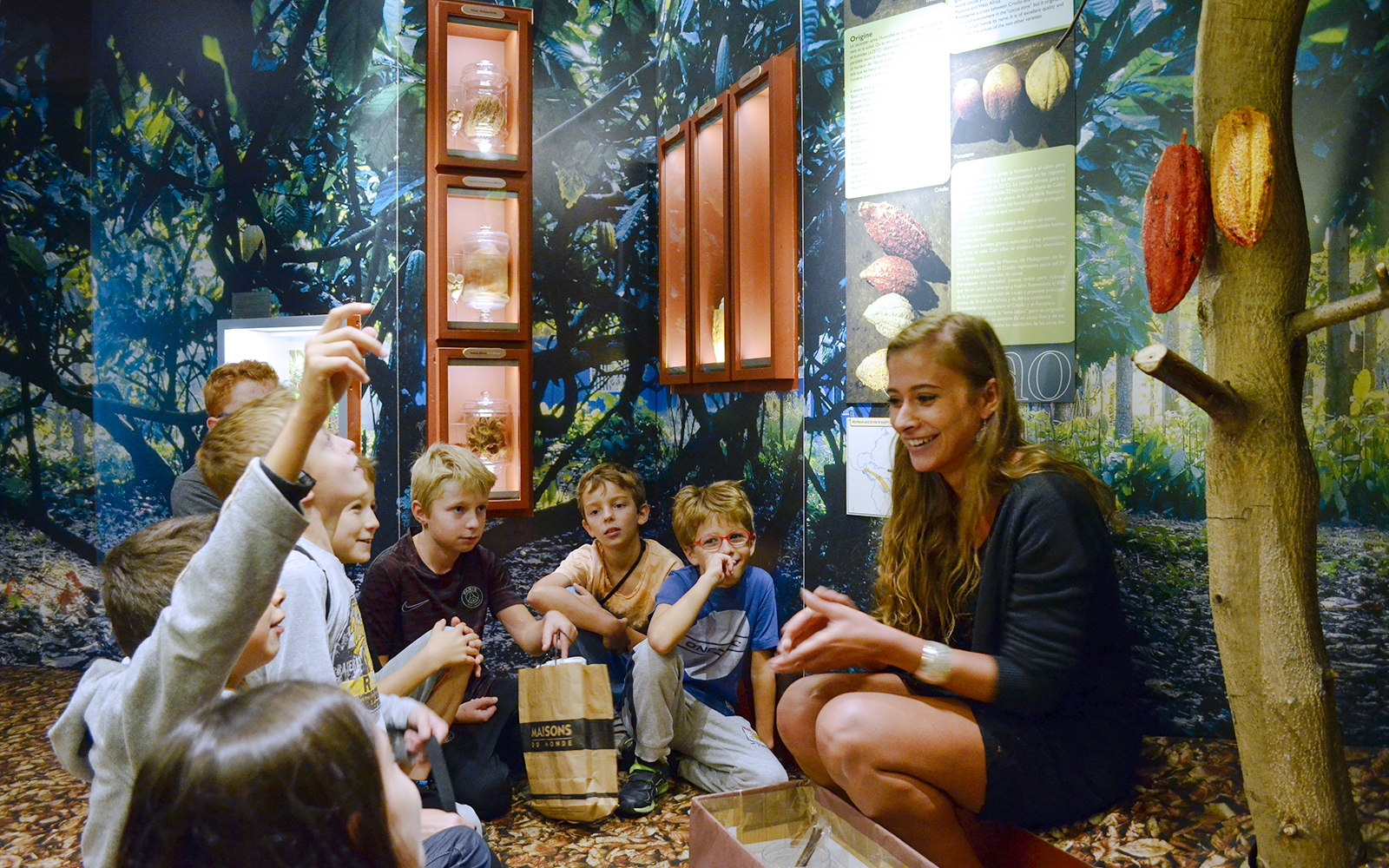 Children learning about cocoa at Choco-Story Paris museum.