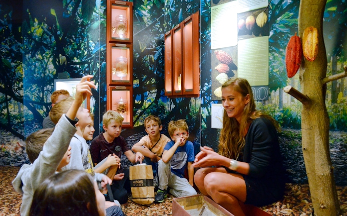 Children learning about cocoa at Choco-Story Paris museum.