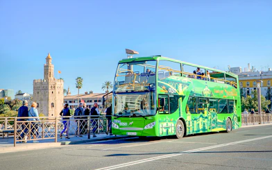 Hop-on hop-off bus near Torre del Oro, Seville.