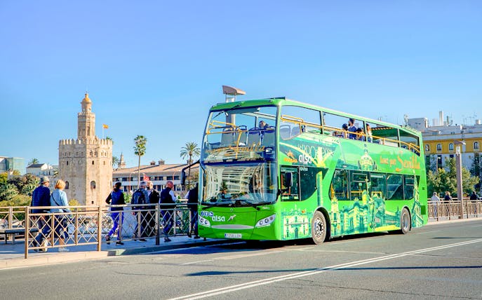 Hop-on hop-off bus near Torre del Oro, Seville.