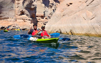 Kayakers exploring Antelope Canyon's rocky waters on a guided tour in Page.