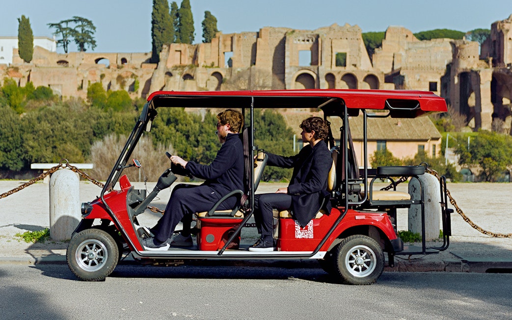 Golf cart tour near ancient ruins in Rome.
