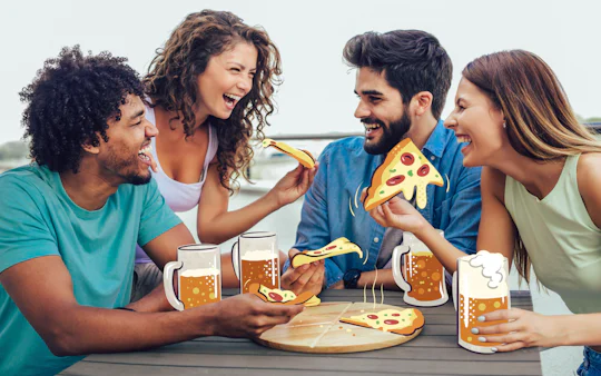 Friends enjoying pizza and beer outdoors, ideal for culinary explorers.