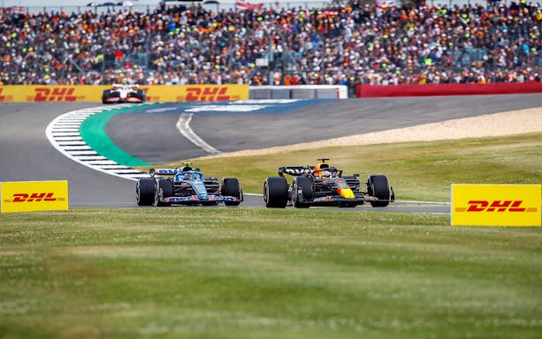 Formula 1 cars racing at the British Grand Prix, Silverstone track.