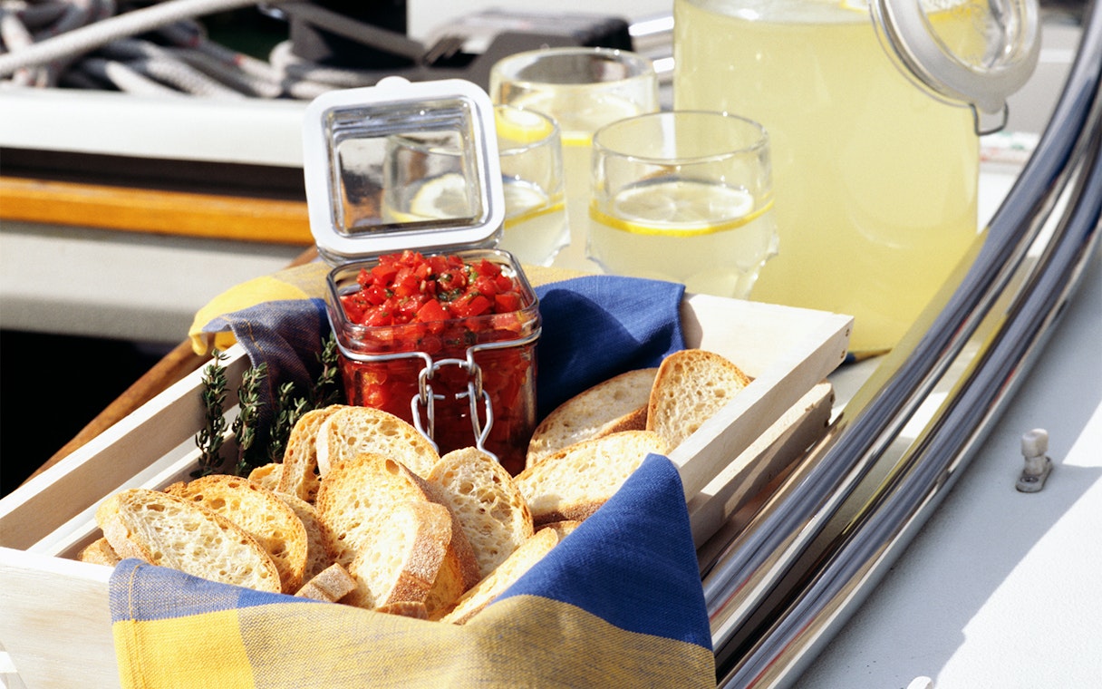 Bread and tomato spread on a yacht with lemonade, Dubai Sunset Luxury Yacht Experience.