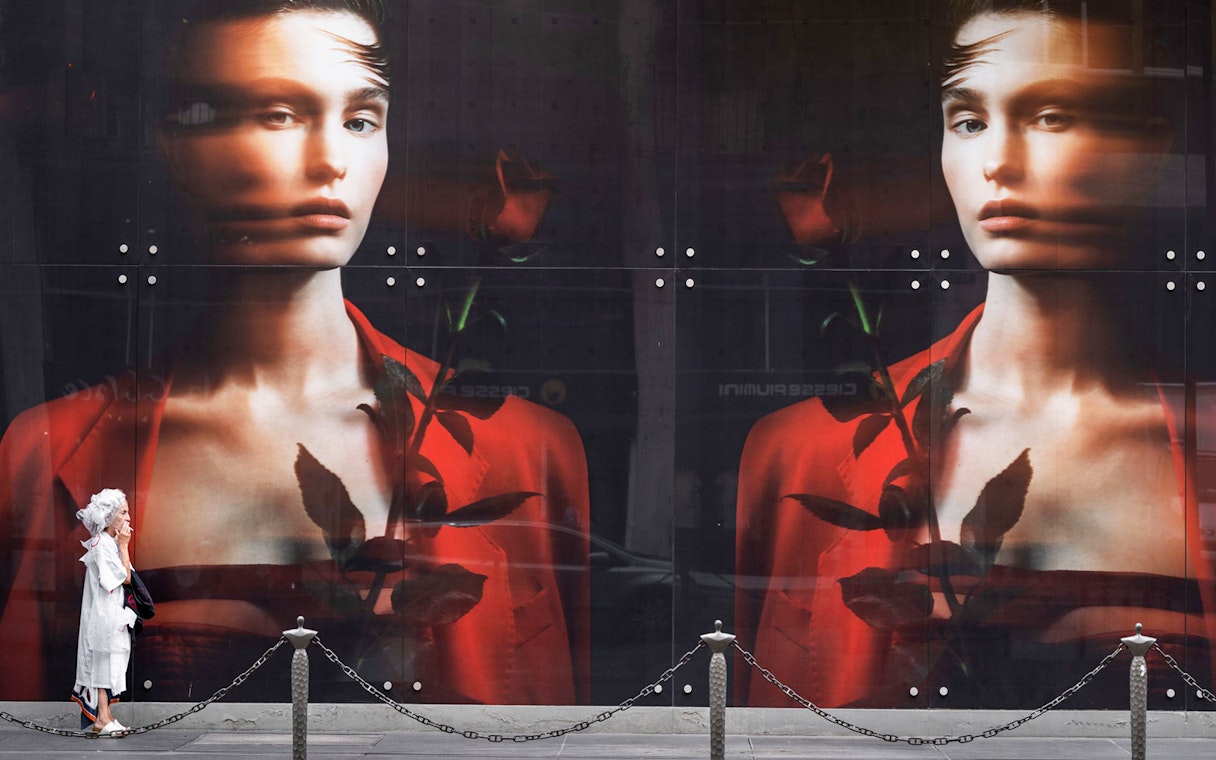 Large fashion poster outside Fundación MAPFRE in Madrid, featuring a model in red with a rose.
