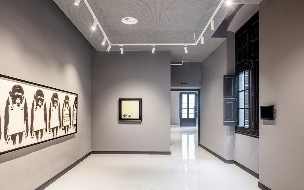 Banksy artwork featuring monkeys at Moco Museum, Barcelona.