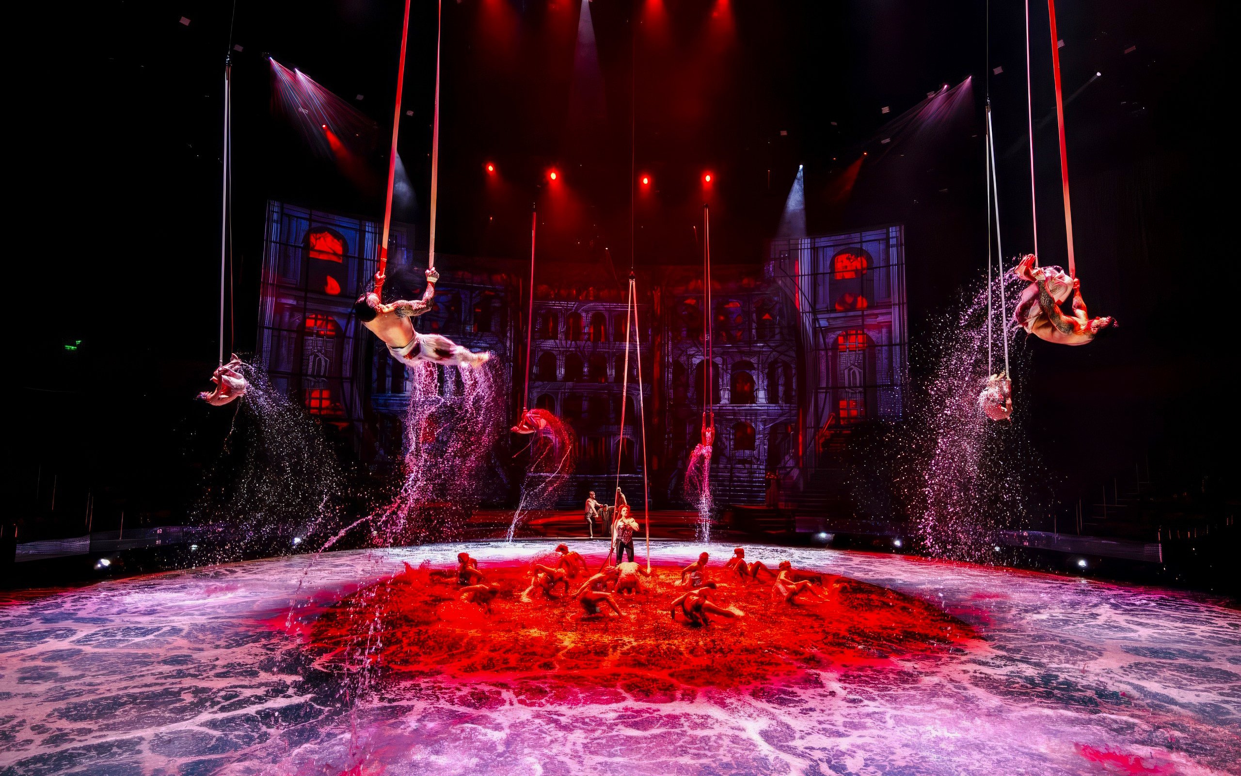 Performers executing rope tricks over water at House of Dancing Water Show.