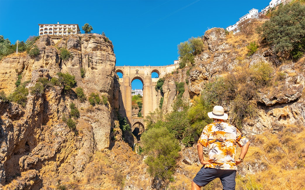 Man admiring Puente Nuevo bridge in Ronda during guided tour of Setenil de las Bodegas and Ronda.