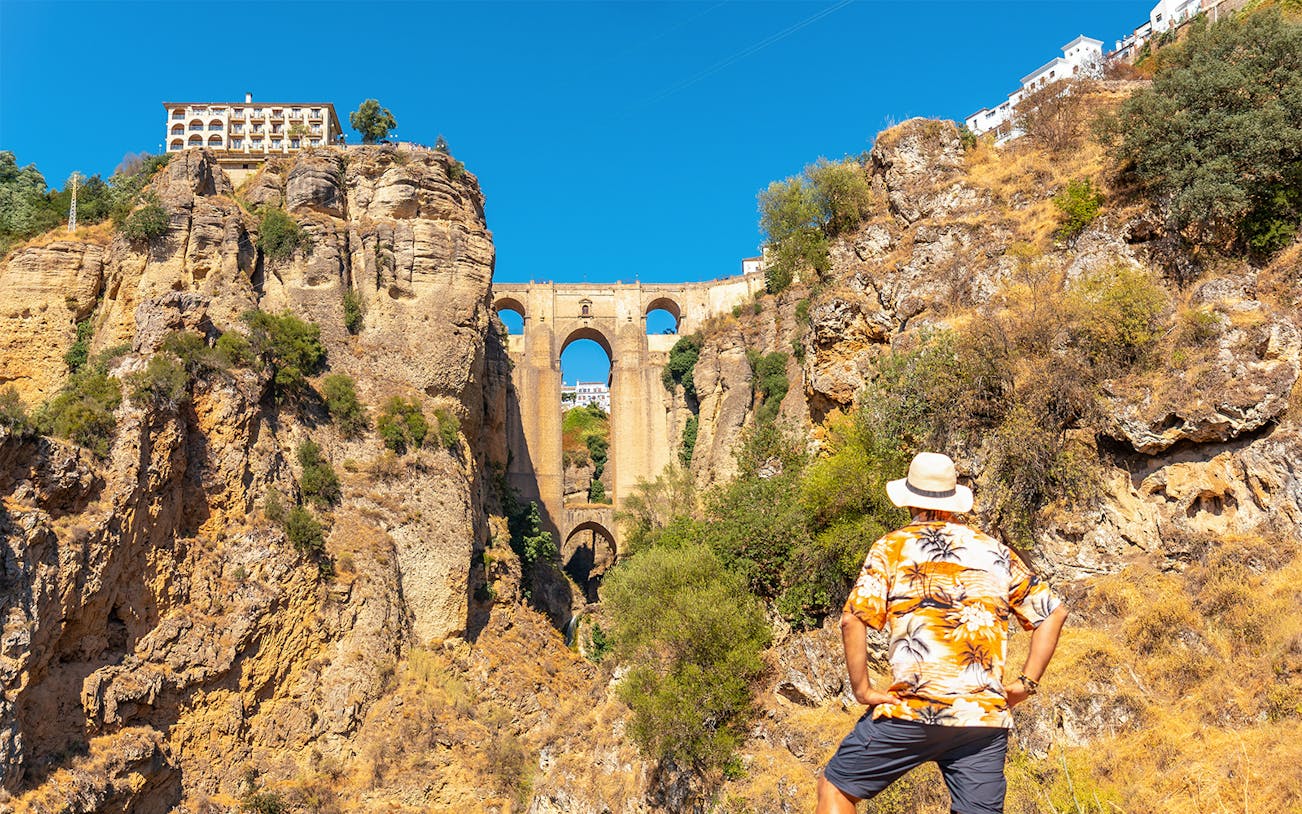 Man admiring Puente Nuevo bridge in Ronda during guided tour of Setenil de las Bodegas and Ronda.