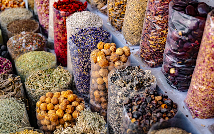 Spices and herbs displayed in bags at Souq Muttrah, Muscat, Oman.