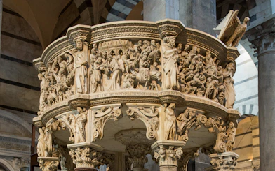 Pisa Cathedral pulpit with detailed carvings, part of the audio guide tour.