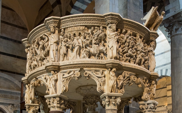 Pisa Cathedral pulpit with detailed carvings, part of the audio guide tour.