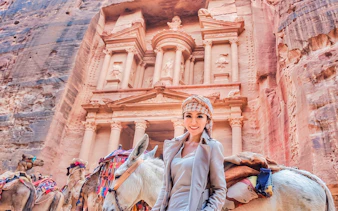 Tourist with camels at Petra's Al-Khazneh, Jordan, during a 2-day tour from Amman.