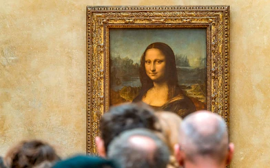 Tourists viewing the Mona Lisa at the Louvre Museum, Paris with reserved access.