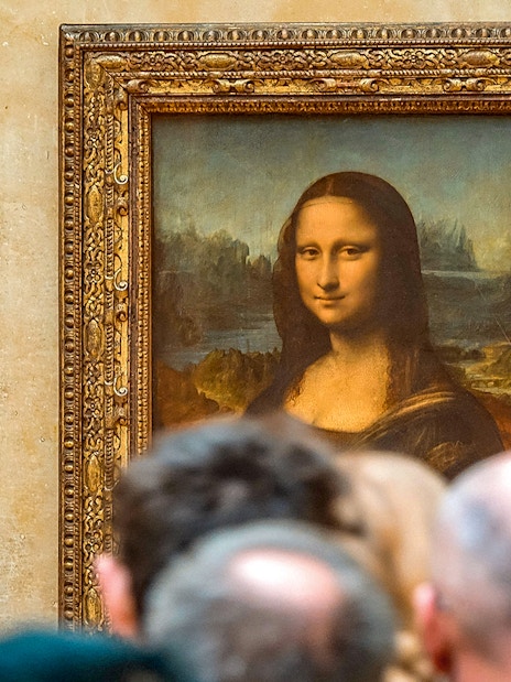 Tourists viewing the Mona Lisa at the Louvre Museum, Paris with reserved access.