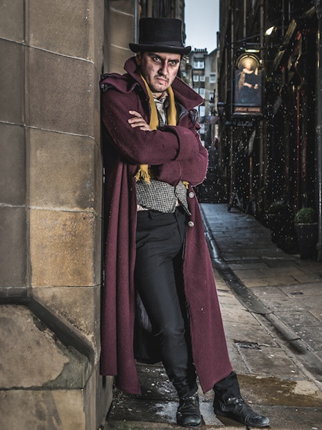 Victorian-costumed actors in a dim Edinburgh alley for the Dungeon Tour.