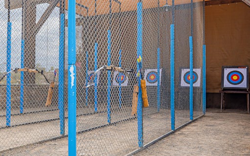 Archery range with targets at Hatta Wadi Hub, featuring bows and arrows.