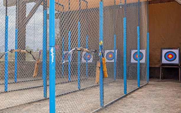 Archery range with targets at Hatta Wadi Hub, featuring bows and arrows.