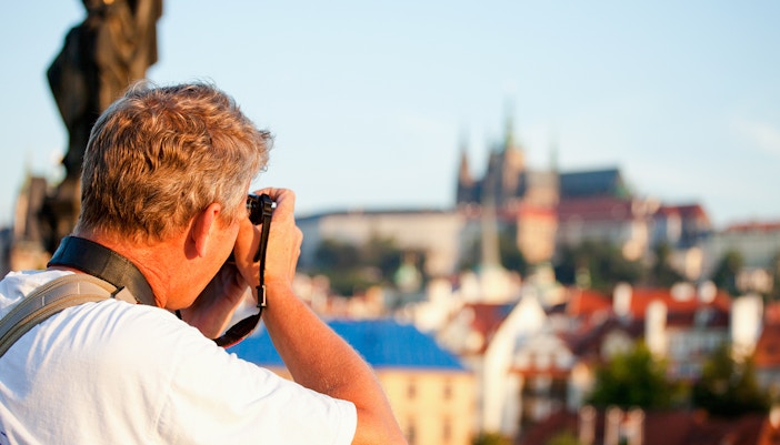 Photographer capturing morning view of Prague skyline.