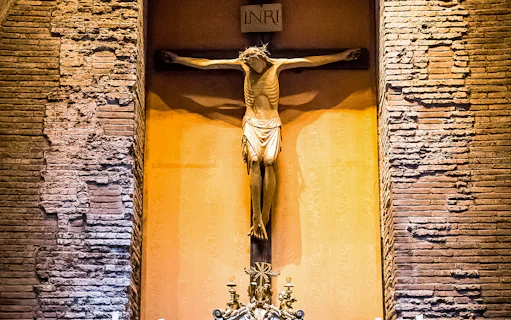 Crucifix inside the Pantheon, Rome, with detailed brick wall background.