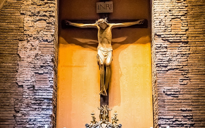 Crucifix inside the Pantheon, Rome, with detailed brick wall background.