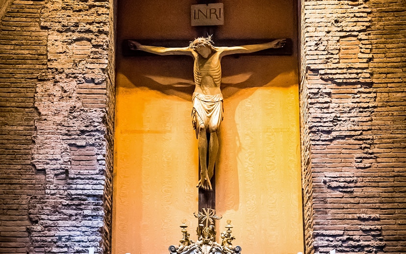 Crucifix inside the Pantheon, Rome, with detailed brick wall background.
