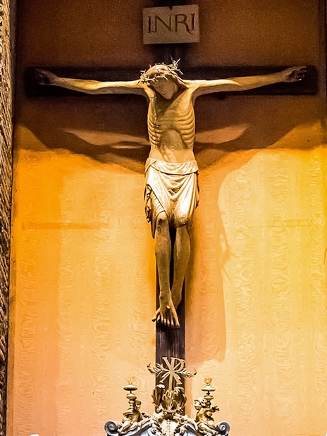 Crucifix inside the Pantheon, Rome, with detailed brick wall background.