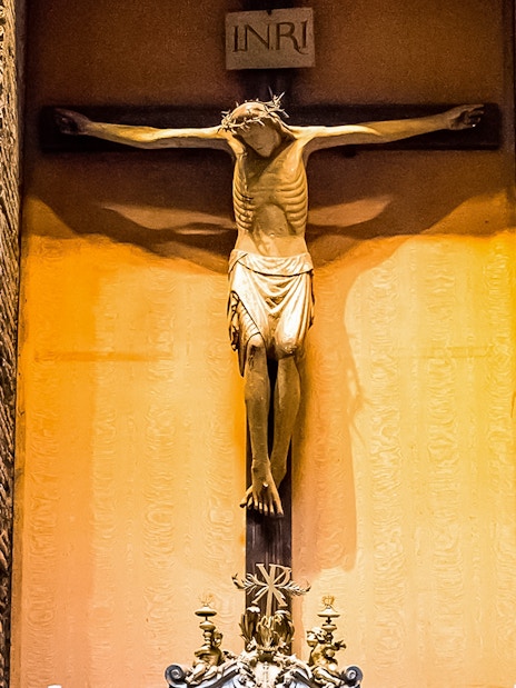 Crucifix inside the Pantheon, Rome, with detailed brick wall background.