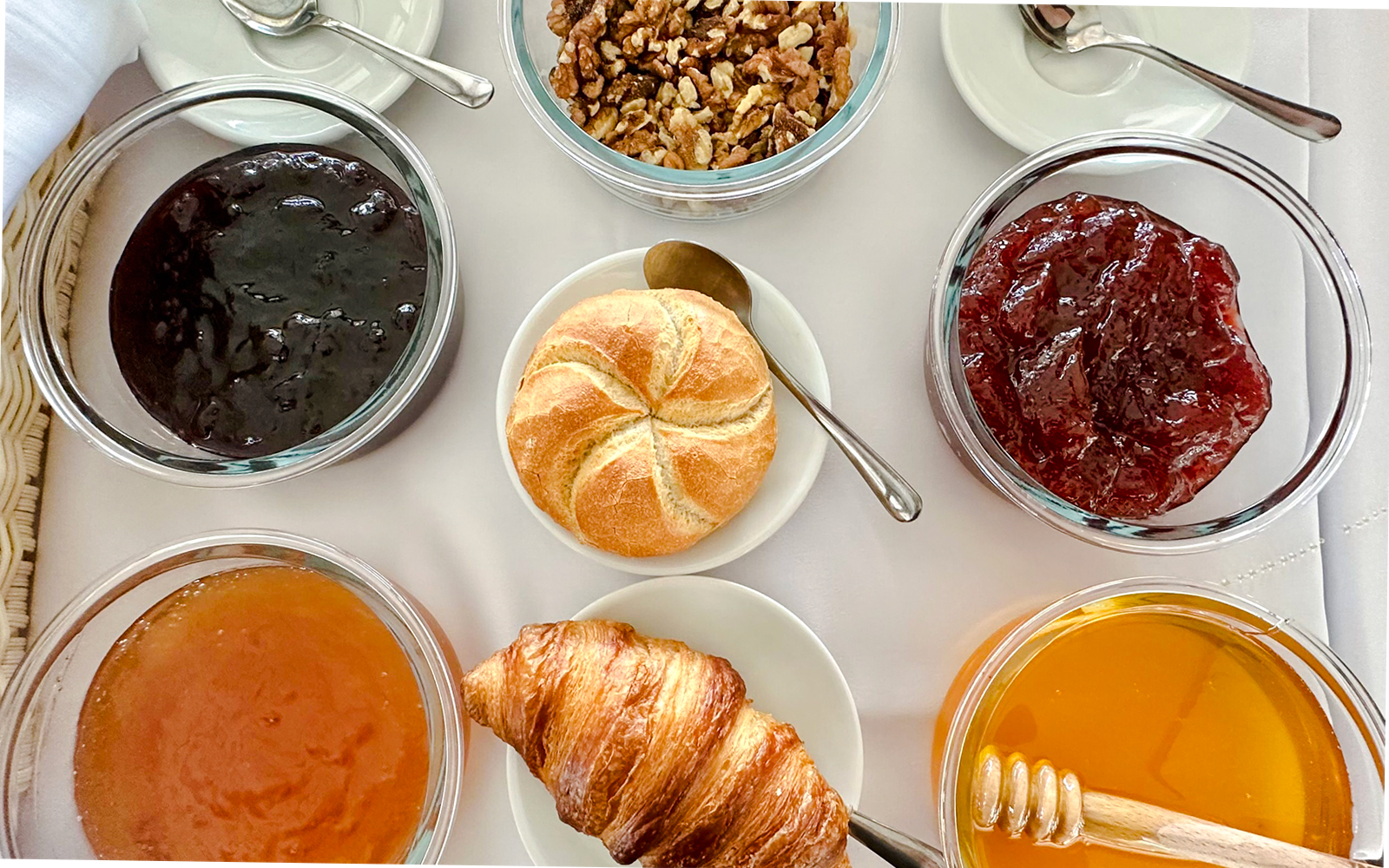 Breakfast buffet with croissant, bread roll, jams, honey, and nuts on Sunshine Booze Cruise, Budapest.