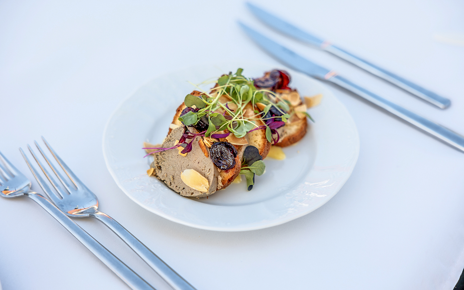 Plate of gourmet appetizers with microgreens served during Sky Bar Prague Aperitivo tour.